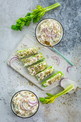 Celery sticks filled with egg and tuna salad, healthy vegetable snack