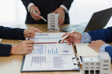 Business meeting of real estate brokers Business working on new startup project, analysis plan,...