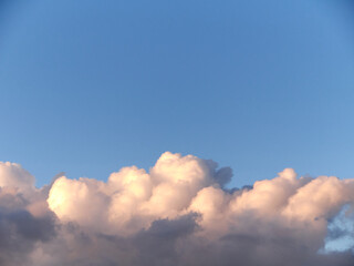 Fototapeta na wymiar White fluffy cumulus clouds in the summer sky, natural clouds background
