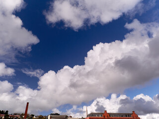 White fluffy cumulus clouds in the summer sky, natural clouds background