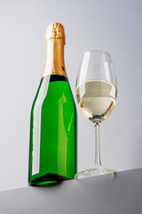 Champagne elegance: Glass and bottle against a grey background