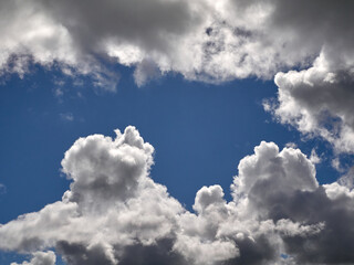White cumulus clouds in the deep blue summer sky. Fluffy clouds background