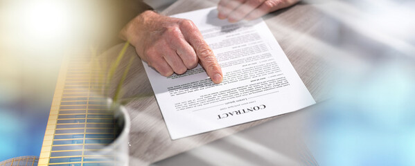 Male hands checking contract; multiple exposure