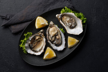 Fresh oysters with lemon on plate
