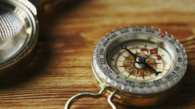 Close-Up of a Classic Compass Beside a Rope on a Wooden Surface During Daylight