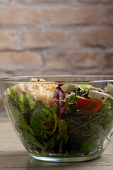 Salad with quinoa, avocado and feta cheese in a glass bowl