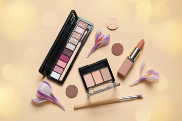 Different makeup products and beautiful crocus flowers on beige background, flat lay. Bokeh effect