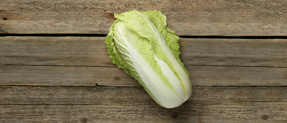 Fresh ripe Chinese cabbage on wooden table, top view. Banner design