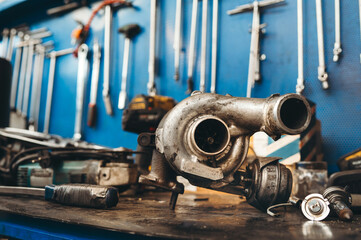 Turbo motor on repairing desk in mechanic workshop