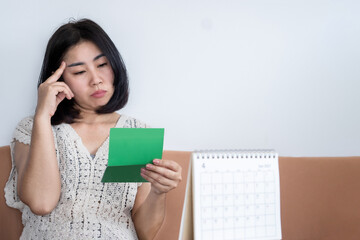  poor bankrupt asian woman checking her money in account book , financial problem concept