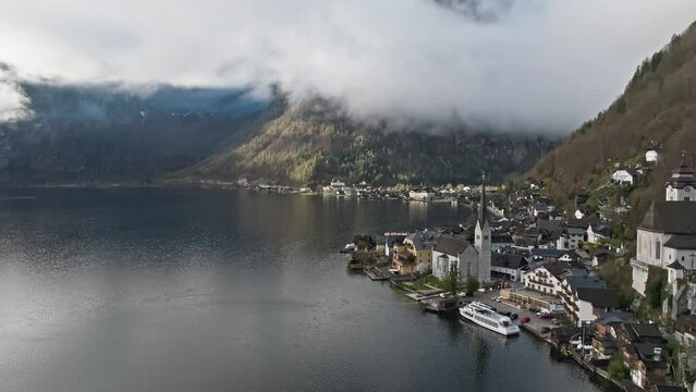 Overlooking hallstatt Austria and the Austrian alps in a slow cinematic fly-away shot