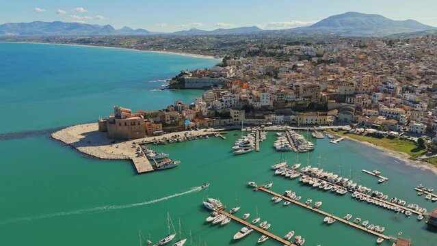 Aerial shot of Castellammare del Golfo, Sicily, Italy. Marina with yachts, old town and mountains in the background in Castellammare del Golfo town, Trapani in Sicily