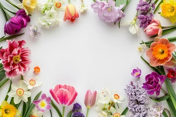Fototapeten Floral background. Spring flowers frame with tulips, daffodils, crocuses, hyacinths, lilacs, cherry blossoms, azaleas on white background. Top view, flat lay, copy space in middle © sania