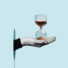 Hourglass in a human hand.  Art collage. - obrazy, fototapety, plakaty