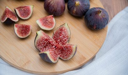 Fresh figs on wooden plate.Delicious fresh figs. wooden background. Close up.