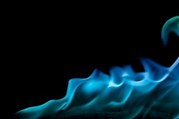 Beautiful blue flames on a horizontal black background.