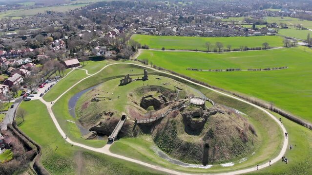 Aerial footage of the ruins of Sandal Castle in Wakefield, West Yorkshire in the UK, this old Castle is near a small town and it also near to farmers field of each side, around the ruins and moat