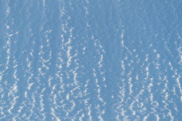 Snow texture. Background of pure blue and white snow. Winter pattern.