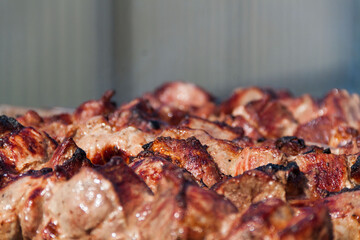 The meat is baked on a skewer on a skewer. Skewers background and texture. Delicious meat with skin.