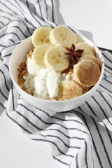 Low Fat Greek Yoghurt, Cottage Cheese Served in Bowl with Freshly Baked Granola and Banana Slices. Healthy Breakfast.