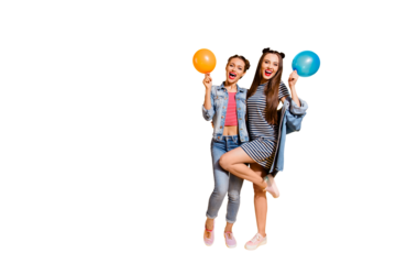 Full legs length body size glad funky funny positive grinning cheerful charming friendly optimist two brunette hair lady stand isolated on yellow wall with copy space for text with fly ball in hands