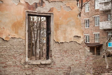 Texture of an old ragged wall background of old bricks and cracks in plaster yellow and brown tones