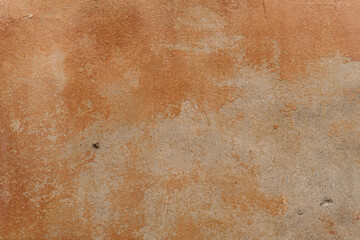 Texture of an old ragged wall background of old bricks and cracks in plaster yellow and brown tones