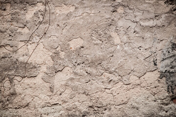 Texture of an old ragged wall background of old bricks and cracks in plaster yellow and brown tones