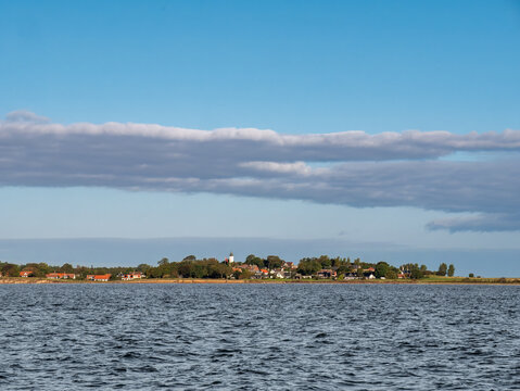 Coastline of Tuno By town with church-lighthouse on Tuno island, Midtjylland, Denmark