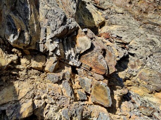 Geodesy. Stone texture. The rock is brown and red. Mineral background. Design from natural materials.