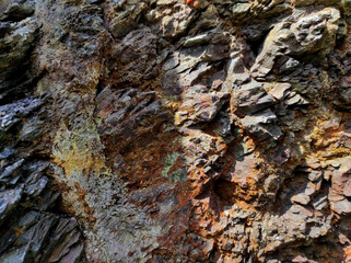 Geodesy. Stone texture. The rock is brown and red. Mineral background. Design from natural materials.