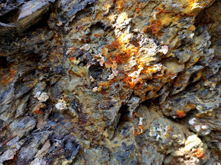 Geodesy. Stone texture. The rock is brown and red. Mineral background. Design from natural materials.