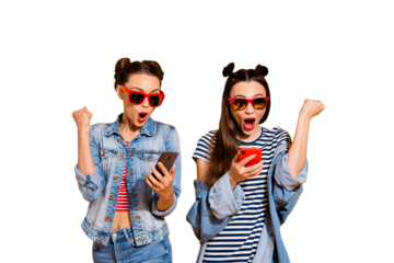 Leader leisure lifestyle wondered wow two lady in street style stylish casual denim jeans outfit trendy glasses spectacles isolated on yellow shine background look on gadget screen raised fists up