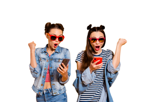 Leader leisure lifestyle wondered wow two lady in street style stylish casual denim jeans outfit trendy glasses spectacles isolated on yellow shine background look on gadget screen raised fists up