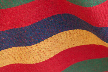 Multicolored wavy striped fabric texture on background.
