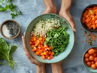 Tuinposter Hands cradling a bowl with a colorful and nutritious grain salad made of couscous, diced carrots, kale, and fresh greens on a textured surface. © Chomphu