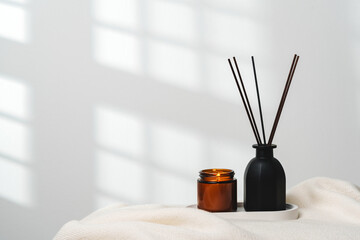 Elegant Aroma Diffuser With Reed Sticks And Scented Candle On White Tablecloth - 773882077