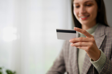 Smiling businesswoman holding credit card for online shopping