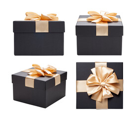 Black gift box with champagne gold ribbon bow isolated on white background