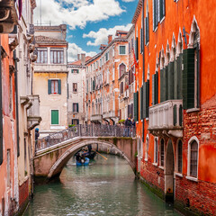 Bridge over a typical canal and its tourists, in Venice, Veneto, Italy
