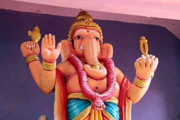 Four-armed Ganesha. A fragment of decoration on the wall of a Hindu temple in southern India.