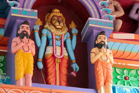 Narasimha, Avatar Vishnu and the sages Rishis. A fragment of decoration on the wall of a Hindu temple in southern India.