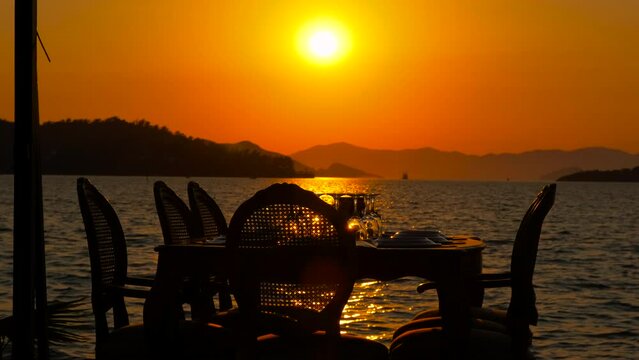 Restaurant table on the background of the sea sunset