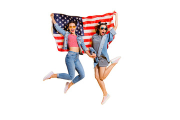 Full legs body size two overjoyed carefree careless tourist travel immigration lady in jeans casual denim wear trendy glasses spectacles jump with English flag isolated on yellow bright background