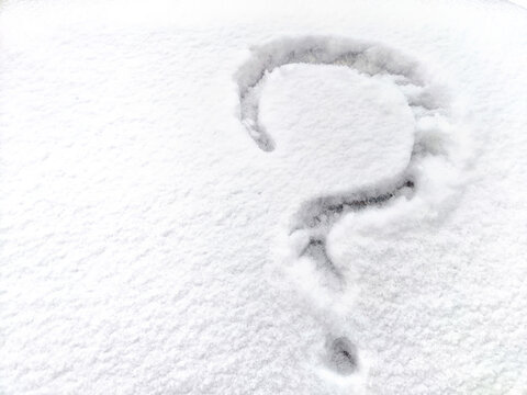 A question mark written in the snow. The cold frosty texture of the snow and the question mark. Background, place for text, copy space