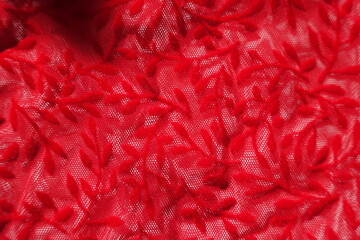 Close view of semi-transparent scarlet red burnout velvet fabric