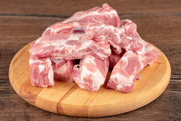 Pile sliced raw pork ribs round on cutting board.