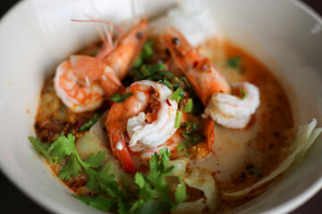 selective focus shrimp looks delicious in a bowl of tom yum shrimp noodles Placed on the table to decorate the table. cooking ideas