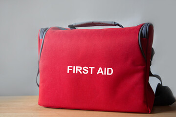 First aid kit medical red bag on table