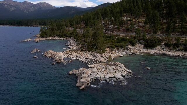 4k Aerial Drone Footage of rocks on shoreline in Lake Tahoe Sierra Nevada mountains in Northern California